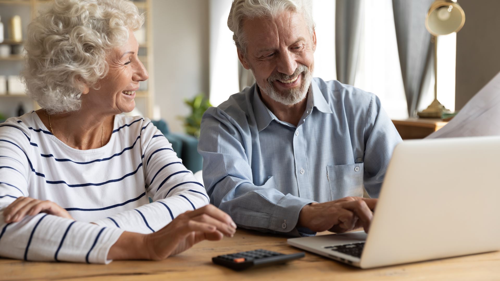 An elderly couple on a laptop