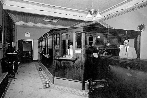 Interior of Oxford Junction Savings Bank - note teller cages and spittoons on floor